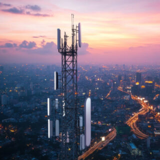 A city's high-speed internet network is shown, with a white tower sending out wireless signals. This represents the 5G technology that provides fast internet access.