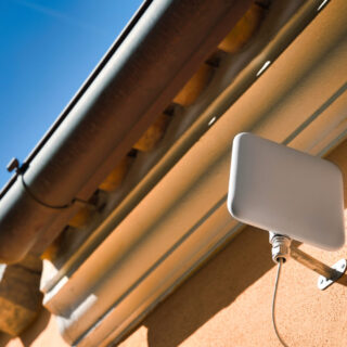 5G Fixed Wireless Access antenna hanging on the wall outside the house