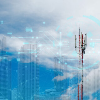 Mobile signal tower, telecommunication with 5G cellular network, global connectivity and internet network concept on sky and city background.